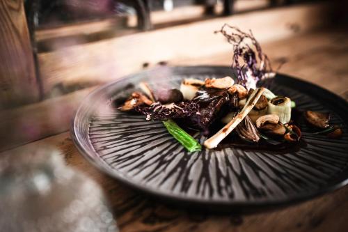 a glass plate with food on a table at Strasserwirt - Ansitz zu Tirol in Strassen