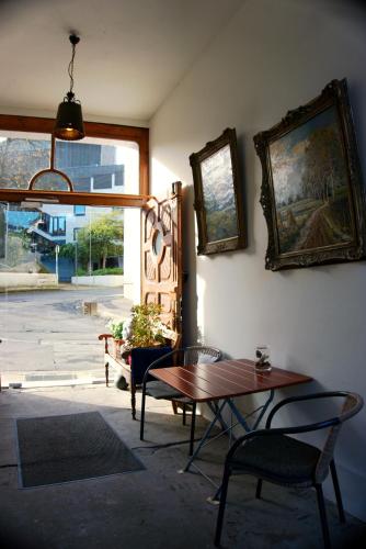a room with a table and chairs and a window at Schillers Hotel & Café - GARNI - in Lüdenscheid