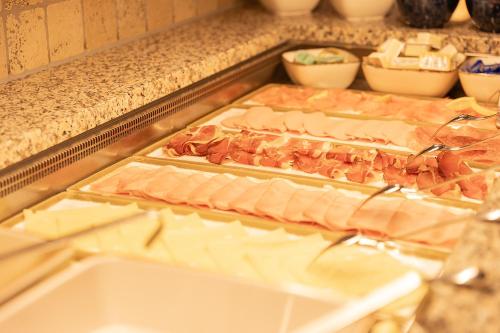two trays of ham and cheese on a counter at Hotel Sonnenheim in Sankt Anton am Arlberg