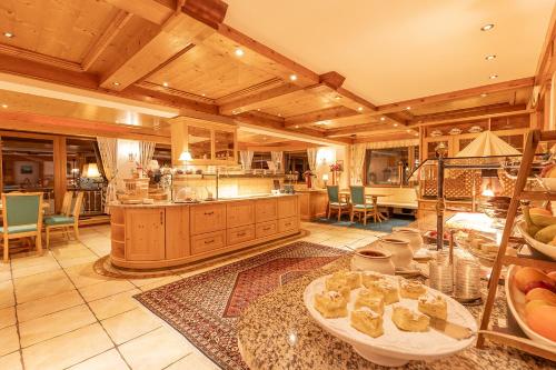 a large kitchen with a table in a room at Hotel Sonnenheim in Sankt Anton am Arlberg
