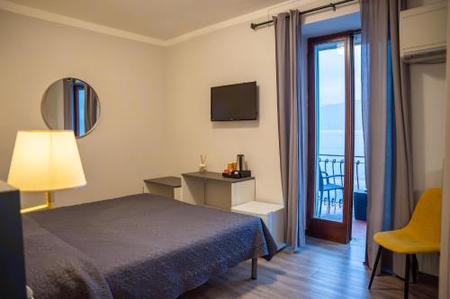 a hotel room with a bed and a balcony at Hotel Romagna in Baveno