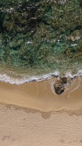 an overhead view of a beach with the ocean at Eden Beachfront Residences & Suites in Kastraki Naxou
