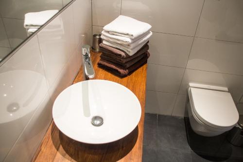 a bathroom with a white sink and a toilet at City Apartments Friedrichshain in Berlin
