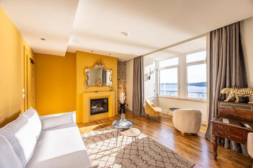a living room with a bed and a fireplace at Restaurant Hotel Didier Méril in Dinard