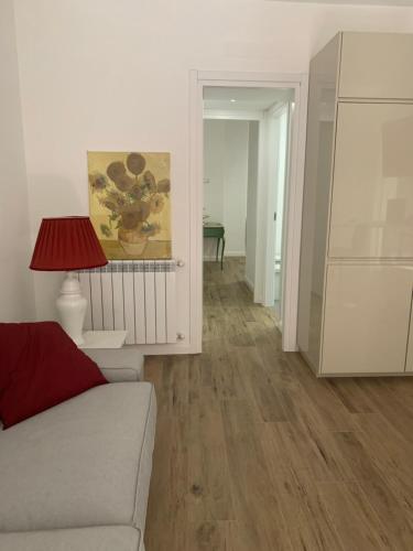 a living room with a couch and a lamp at Scipioni Relais in Rome