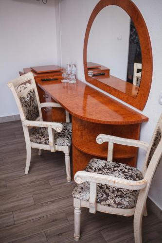 a dressing table with two chairs and a mirror at Hotel LUDMIR in Volodymyr-Volynsʼkyy