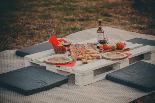 a picnic table with a bottle of wine and food at Agriturismo Podere San Giorgio in Radicofani