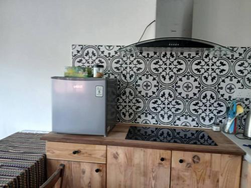 a kitchen with a black and white pattern on the wall at Preece's Homestay in Kuala Lumpur