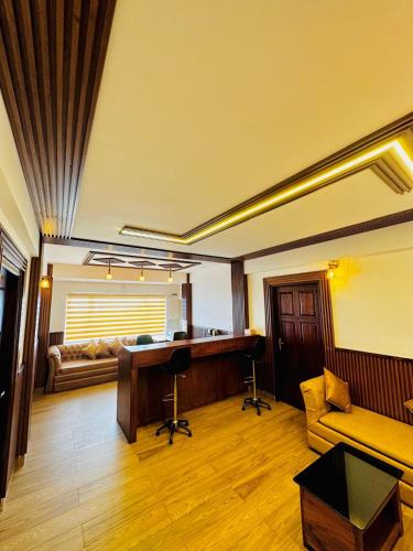 a living room with a desk and a couch at Kanavu Valley View in Ooty