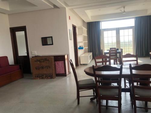 a living room with a dining room table and chairs at IT City Homestay-Secure & Comfortable Stay in Mohali in Mohali