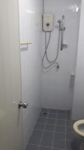 a small bathroom with a shower and a toilet at the three pyramids in Phuket