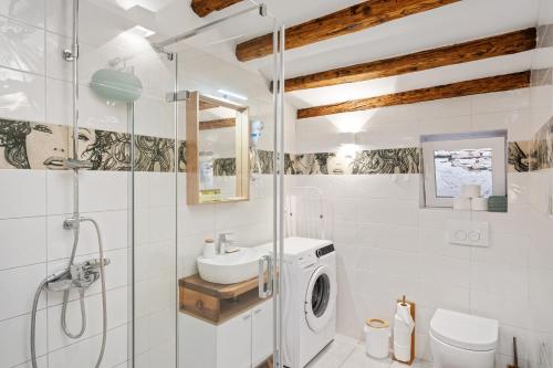 łazienka z umywalką i pralką w obiekcie Apartman tutto bene w Rovinj