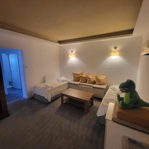 a living room with a dog sitting on a couch at Pensiunea 4 Salcii in Băltenii de Sus