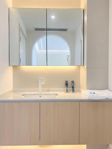 a bathroom with a sink and a mirror at Eastern Hub - Three Bedroom Apt in Xintiandi, 50m from Metro, Many Shops and Malls Surrounded in Shanghai