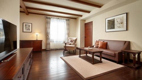a living room with a couch and a table at Lotte Arai Resort in Myoko