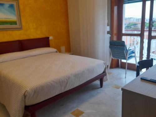 a hotel room with a bed and a balcony at Sunlight Suite in Termoli
