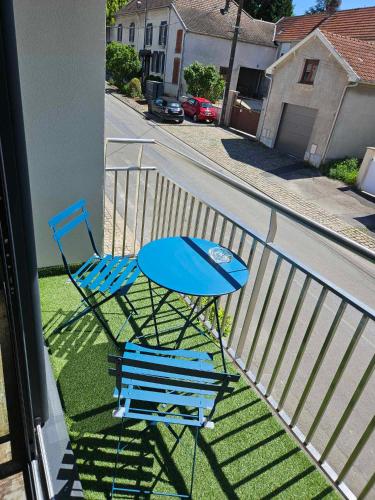a blue table and two chairs on a balcony at Les Bulles de Bonheur - Au Cœur du Vignoble Champenois in Chouilly