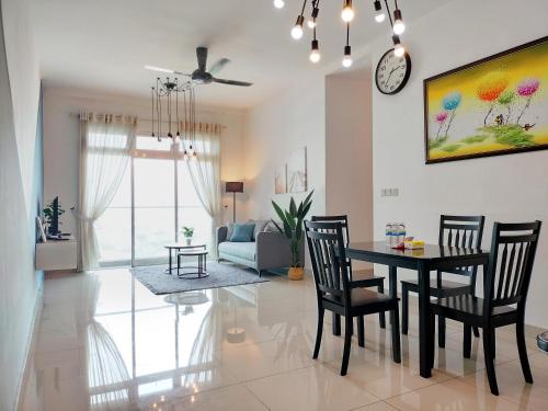 a dining room and living room with a table and chairs at Delight Homestay Twin Galaxy Studio Room in Johor Bahru
