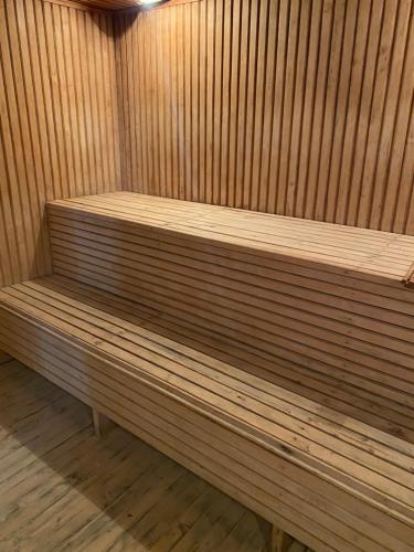 a wooden bench sitting in a sauna at Момент in Yuzhnoukrainsk 