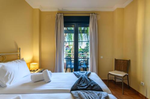 a bedroom with a bed and a window with a patio at El Rincon del Golf II PLUS by Ĥ - Isla Canela Golf GRHII27P30 in Isla Canela