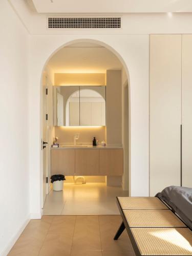 a bathroom with a sink and a mirror at Eastern Hub - Three Bedroom Apt in Xintiandi, 50m from Metro, Many Shops and Malls Surrounded in Shanghai