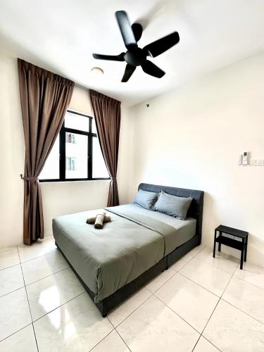 a bedroom with a bed with a ceiling fan at The Sun Residence Bayan Lepas in Bayan Lepas