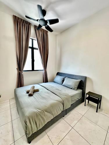 a bedroom with a bed with a ceiling fan at The Sun Residence Bayan Lepas in Bayan Lepas