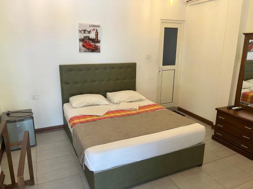 a bedroom with a bed and a tv in it at Royal Crown Residency Hotel in Talawatugoda