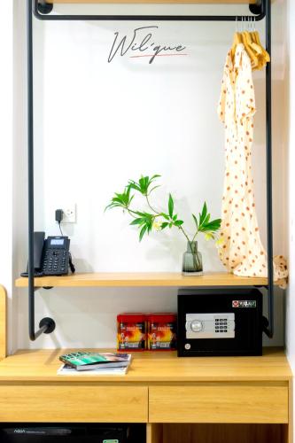 a desk with a microwave on top of it at Wilque Hotel Hanoi in Hanoi