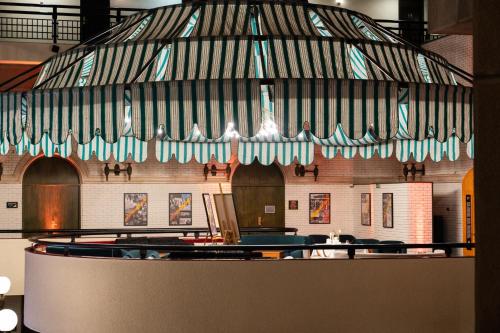 a restaurant with a bar with a striped ceiling at Hotel Holiday in Sarajevo