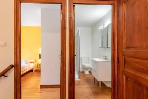 a bathroom with a sink and a toilet in a room at Maison Jumelée avec terrasse - A 200m du lac d'Annecy in Sévrier