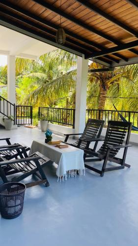 a group of chairs and a table on a patio at COCO Rooms in Galle