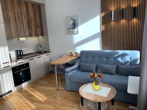 a living room with a blue couch and a table at Premium Design, Renovated 2024 Free parking in Riga