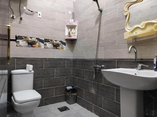 a bathroom with a white toilet and a sink at Mooody nobin haws in Abu Simbel