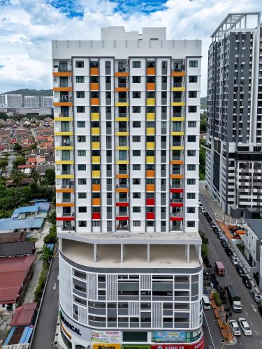 an overhead view of a tall white building with colorful windows at The Sun Residence Bayan Lepas in Bayan Lepas