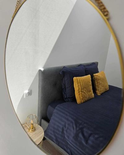 a mirror reflection of a bed in a room at Les Bulles de Bonheur - Au Cœur du Vignoble Champenois in Chouilly