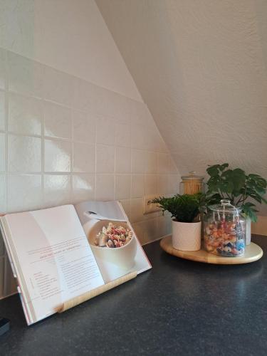 a book sitting on a counter with a bowl of candy at The Carmelite in Ypres