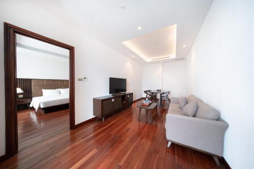 a living room with a couch and a mirror at Green Beach Hotel Nha Trang in Nha Trang