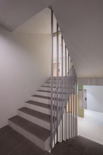 a staircase in a building with a metal railing at ซิตี้วรรณ ราชบุรี in Ratchaburi