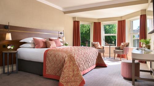 a hotel room with a bed and a desk at Tulfarris Hotel and Golf Resort in Blessington