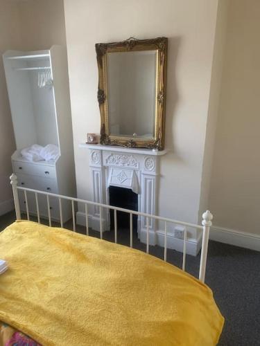 a bedroom with a mirror and a bed with a yellow blanket at Apartment, Stylish 2 bed Riverside House, 2 Kingsize beds, Free Parking in Southampton