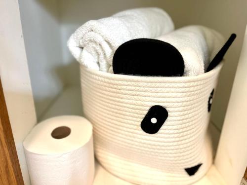 a basket of toilet paper next to a roll of toilet paper at Custom luxury house in Katy near I10 and 99 in Katy