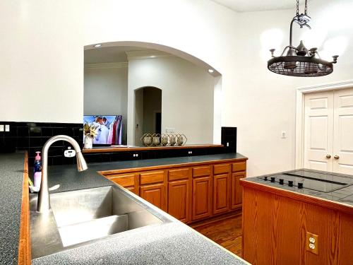 a kitchen with a sink and a large mirror at Custom luxury house in Katy near I10 and 99 in Katy