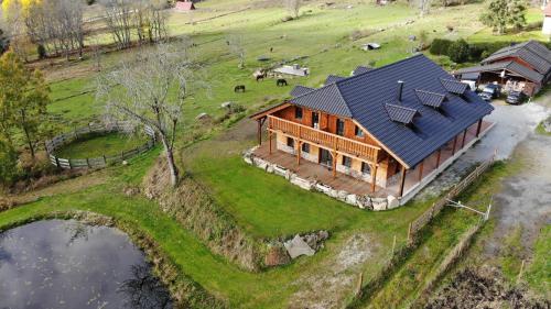 an overhead view of a large wooden house on a farm at Penzion Farma Žleby in České Žleby