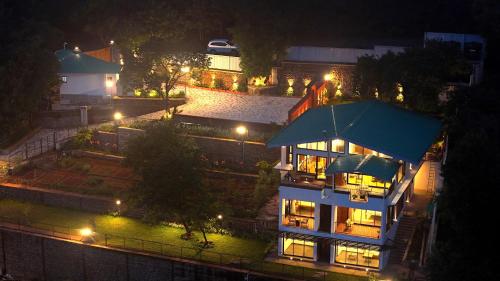a night view of a building with lights at Par-X - Villa Sukoon - 3BHK Valley View - Leave the World Far Behind in Satara