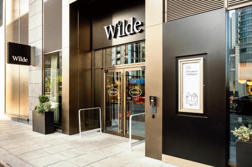 a white sign on the side of a building at Wilde Aparthotels London Paddington in London