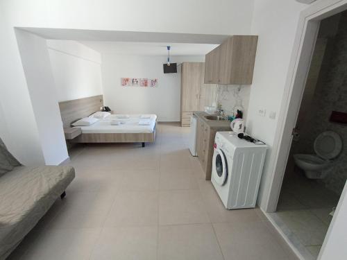 a bathroom with a washing machine and a sink at Aialion studios & apartments - Steve Apartments in Rhodes Town