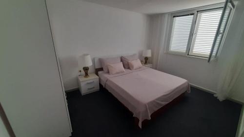 Postel nebo postele na pokoji v ubytování Apartments Lapa