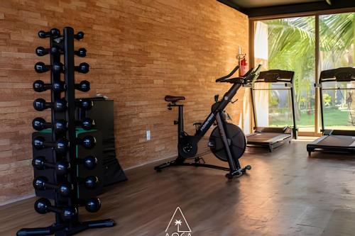 a gym with a treadmill and a exercise bike at Villa Naluri - Seu Refúgio a 50 metros da praia em Japaratinga in Japaratinga