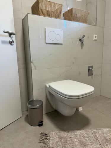 a bathroom with a toilet and a trash can at City Residenz , Europa-Park - Rulantica in Lahr